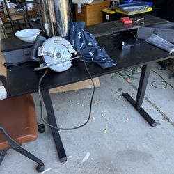 Black adjustable height, desk, and office chair