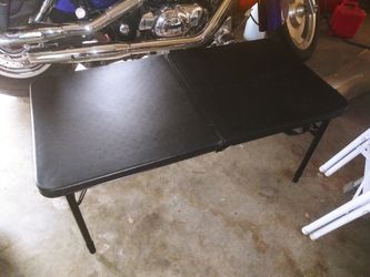 Black plastic folding table