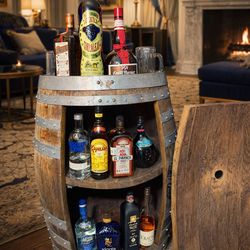 Handcrafted bar cabinet made from a wooden barrel.