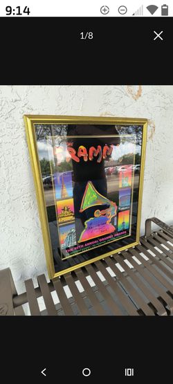 This item is a framed original vintage poster from the 2003 45th Annual Grammy Awards, featuring cover art designed by artist Peter Max. The poster sh