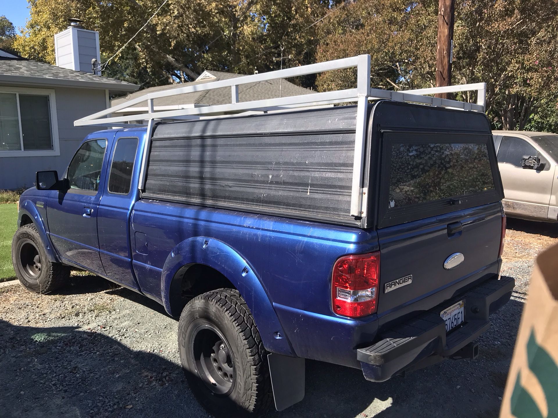 Camper shell with lumber rack