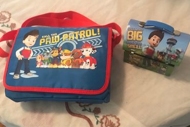 Paw patrol DVD player with a tin of paw patrol toys, and two DVDs