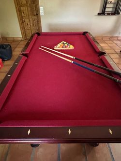 Pool table and sticks set.