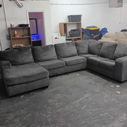Large dark gray sectional couch with Chase