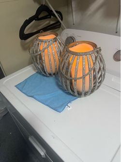 Two large candle holders with wax battery candles