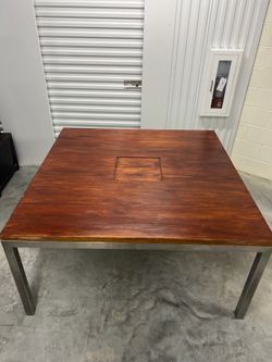 Solid Walnut dining table , stainless steel base.
