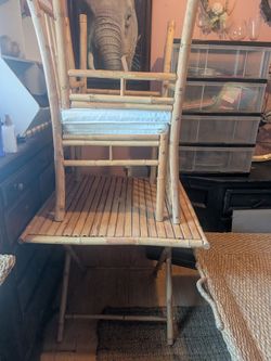 2 bamboo chairs and folding table