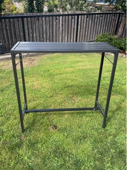 Tall skinny outdoor metal table