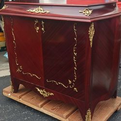Antique phonograph housed within a decorative wooden cabinet, likely from the early 20th century