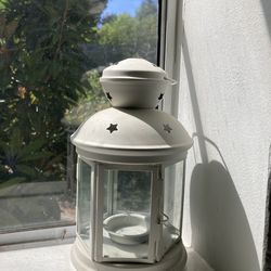 Decorative lantern with star cutouts, perfect for candles.