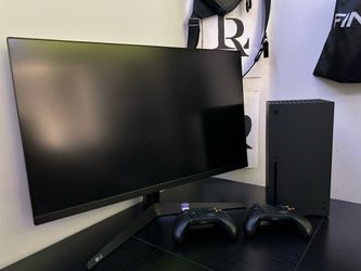 X box series x ,two controllers and a monitor