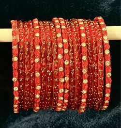 Red Embellished Bangles Set with Gold Stones