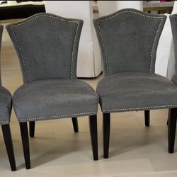 Gray/Cheetah chairs with studded trim.
