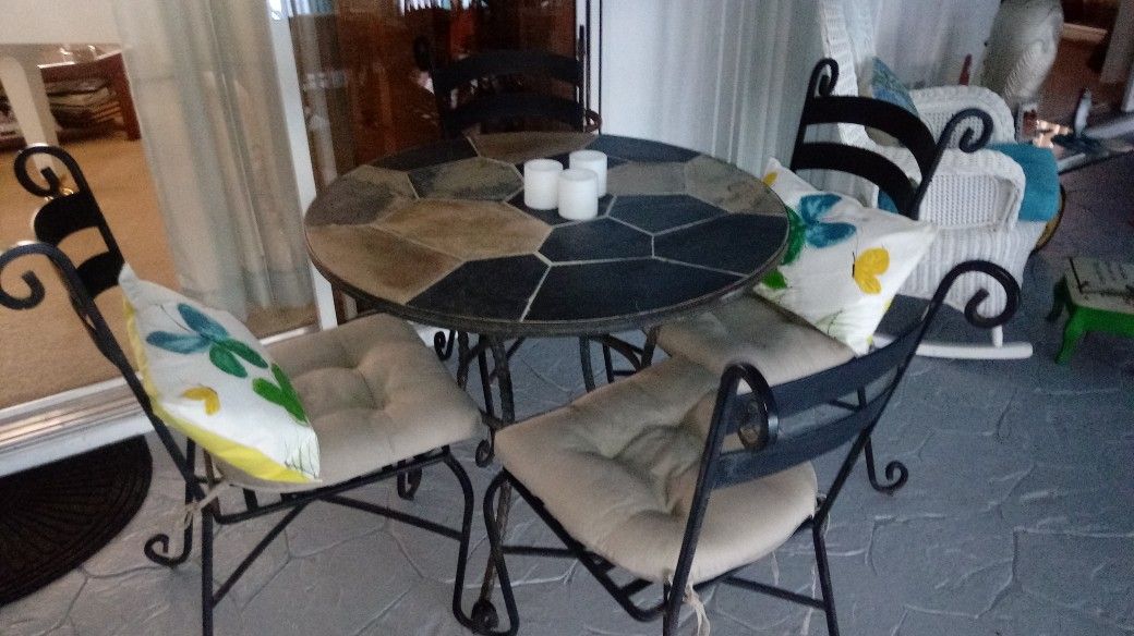Pier One bistro set ,slate top 4 chairs and pads. Slate and wrought iron $200