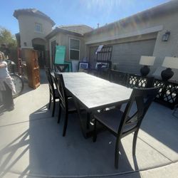 Black dining room table with six chairs