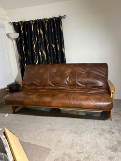 Beautiful leather couch falls down into a bed