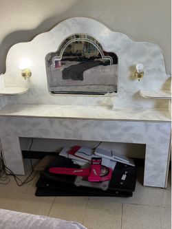 Vintage white headboard with mirror and built-in lamps.
