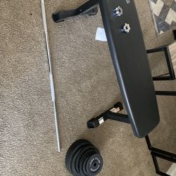 Exercise Barbell With Weights And A Weight Bench 