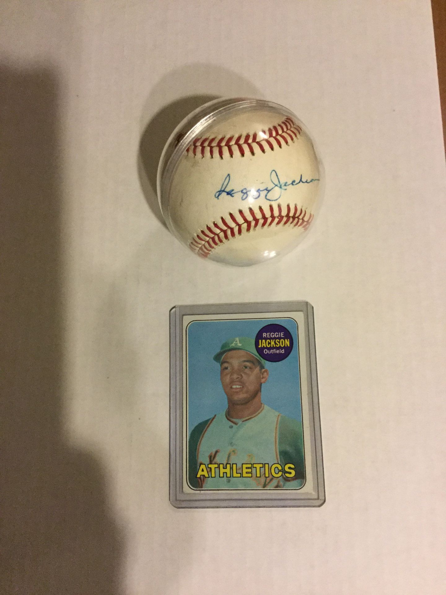 Reggie Jackson rookie baseball card and autographed baseball