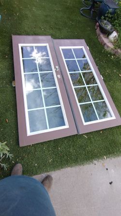 French door solid wood. .double glass grill.   Hinges.  Good condition.  Size. 60" inches wide X .80" inches tall.    $.   250.