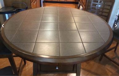 High top dining table 36" H. Heavy, well made. Storage bin under table