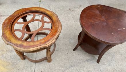 2 small brown round coffee tables