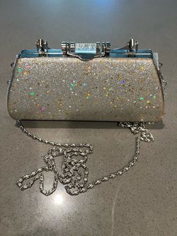 Sparkling silver clutch with holographic star accents.