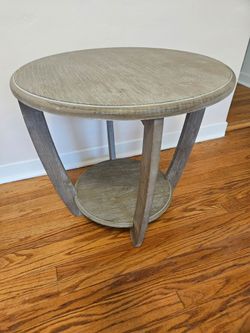 Neutral gray side table with curved frame