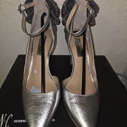 silver heels, with a bow at the back Size 7.5