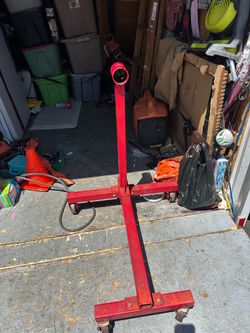 Overview                        This is a red, heavy-duty automotive engine stand featuring a robust steel H- or I-base design with caster wheels and 