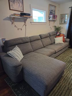 Gray sectional couch with storage and table