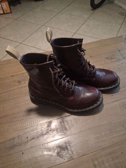 These are the classic Dr. Martens 1460 8-eye boots in a rich cherry red finish. Women size 8.