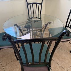Round glass dining table with chairs