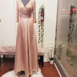 Flatteringly feminine Rosegold dress.  Lavishly adorned with twinkling sequins in the faux wrap style bodice that features a ruching detail