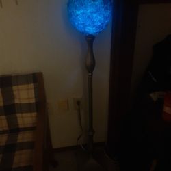 Antique Floor Lamp with a thick blue chip glass globe. 