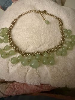 Green necklace with dangly balls in set of 2 across from of necklace