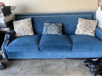 A couch, a rug, and a side chair