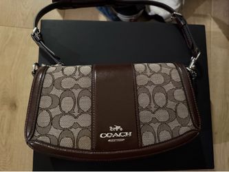 Coach Andrea Shoulder Bag featuring a signature jacquard pattern and a central leather accent.Brand: CoachModel: Andrea Shoulder Bag