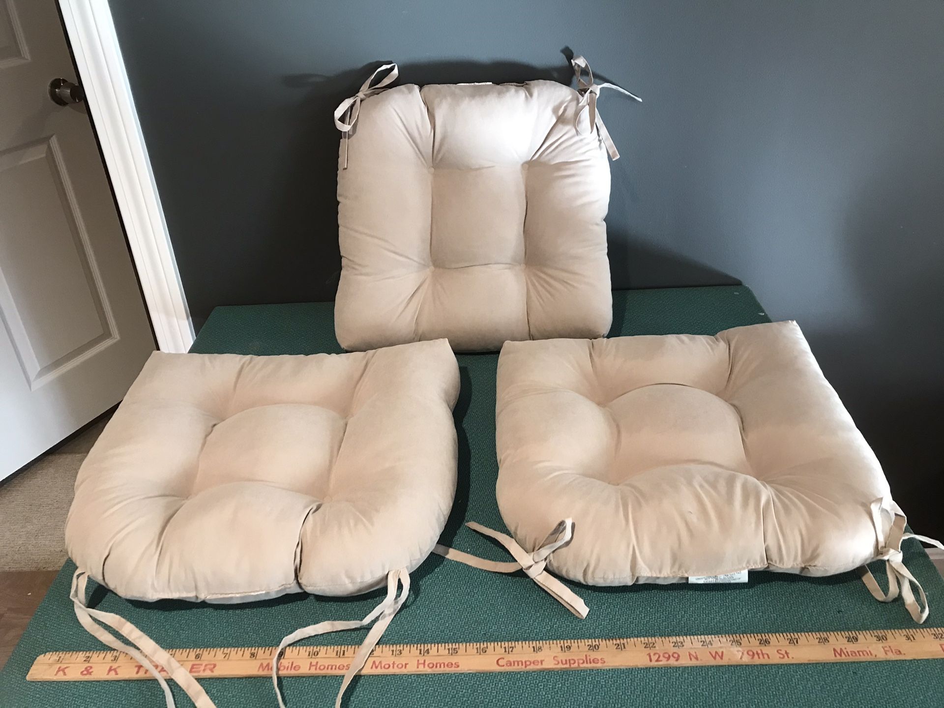 3 tan sueded, tufted chair cushions