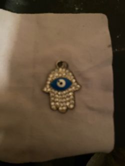 Stainless steal hamsa hand pendant adorned with rhinestones plus blue evil eye