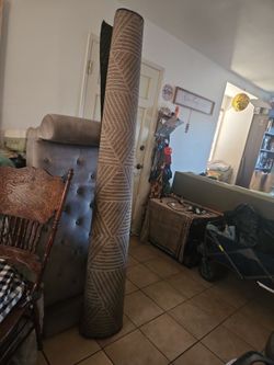 Large Rolled Area Rug with Geometric Pattern