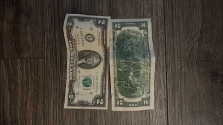 Two individual two dollar bills
