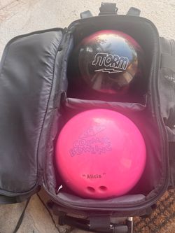 2 bowling balls and bag with wheels