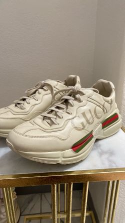 Gucci Rhyton sneakers in ivory leather featuring the vintage logo and signature web stripes.
