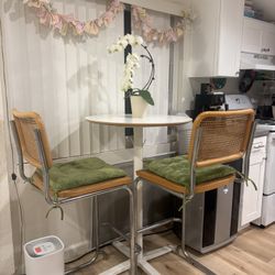Tall dining table with rattan bar chairs