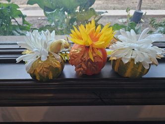 Set of three decorative pumpkins with artificial flowers & decor.