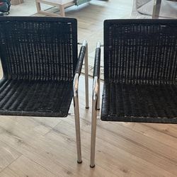 2 Black Rattan Arm Chairs