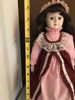 Burgundy dress music doll