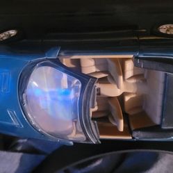 Maisto or Ertl 1:18 scale diecast model of a blue convertible with a tan interior. Visual search results suggest it is likely a 1996 Chevrolet Camaro 
