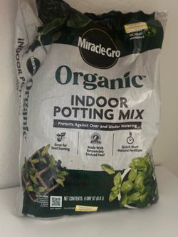 2 bags of soil & small pot for plant